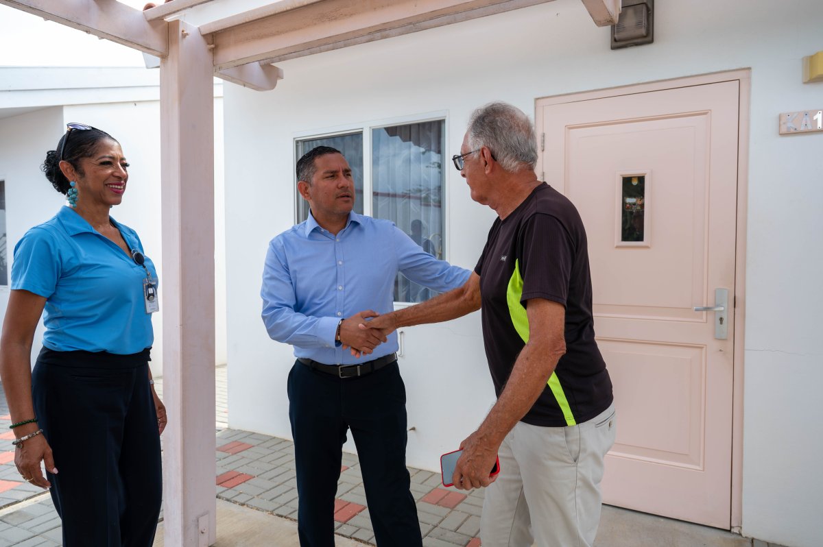 Government officials discussing funding for seniors house