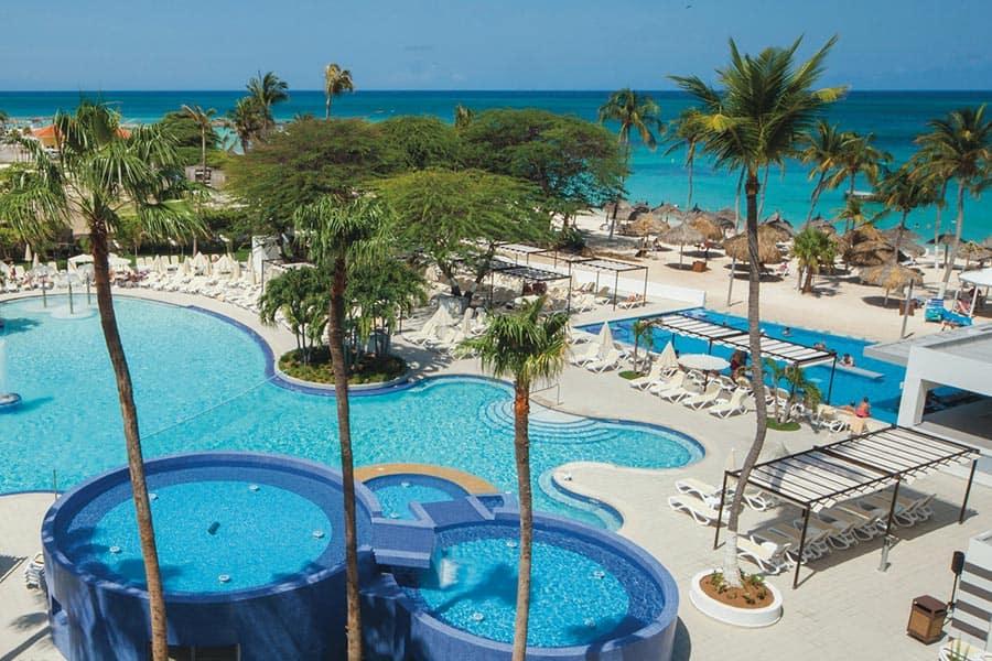 Stunning beachfront view of Hotel Riu Palace Antillas in Aruba with clear blue waters.