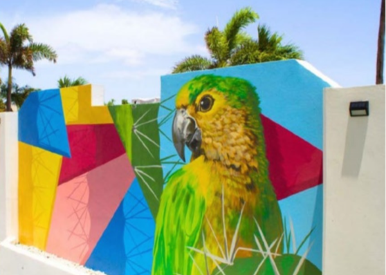 A beautiful view of the resort's main building and pool area at Brickell Bay Beach Resort, Aruba.