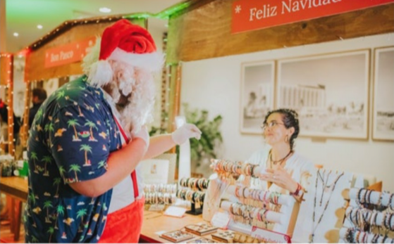Santa greeting guests on the beach during the holiday season at Hilton Aruba.