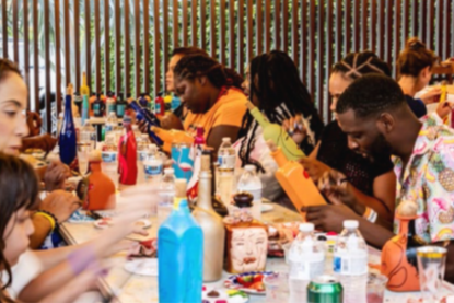 Guests painting bottles with local artists at Radisson Blu Aruba’s creative workshop.