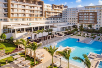 Guests lounging by the pool at Embassy Suites Aruba, enjoying the tropical setting.