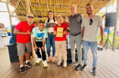 Playa Linda Beach Resort team celebrating their hospitality awards under the Royal Palapa.