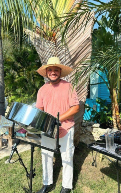Guests enjoying live steel drum music during International Happiness Day at Boardwalk Boutique Hotel