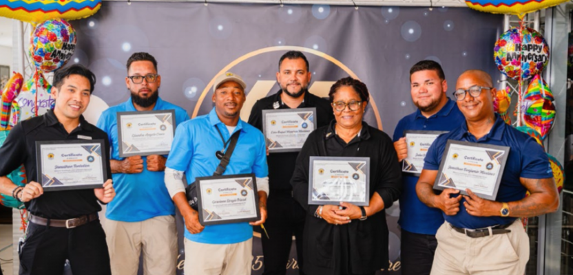 Team members celebrating milestone achievements at De Palm Tours 2025 event