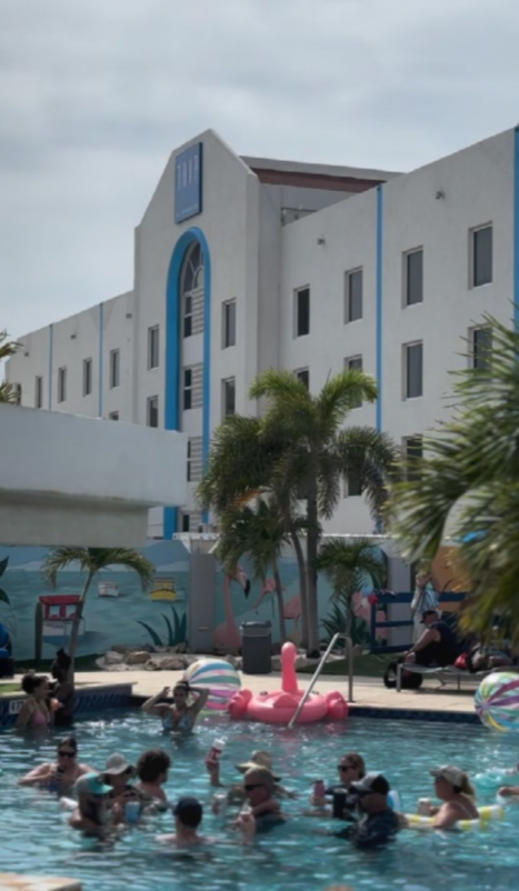 Guests celebrating the 4th of July poolside with BBQ and live DJ at TRYP Aruba