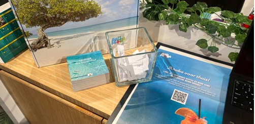 Aruba-themed tote bags and goodie boxes on display during TUI in-store activation