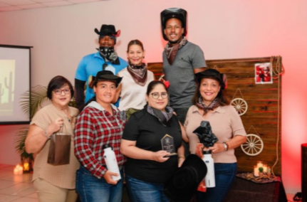 De Palm Tours executives presenting recognition awards to staff