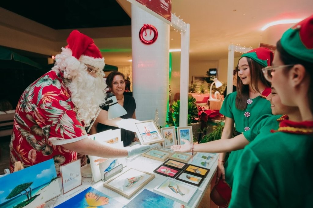 Santa Claus shops handmade gifts with local artisans at Hilton Aruba Holiday Markets