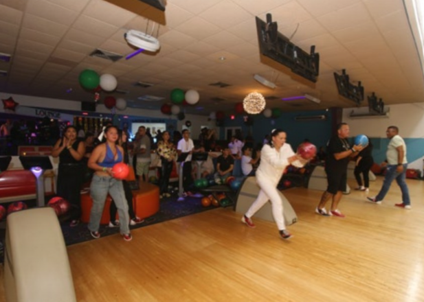 De Palm Tours staff enjoying bowling and teamwork during anniversary event