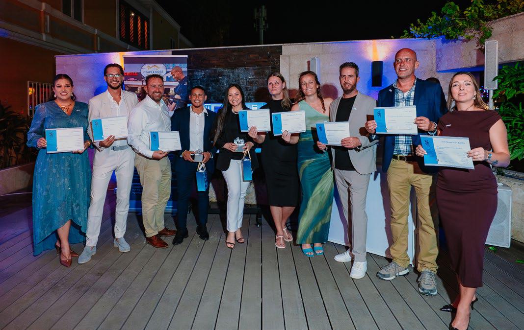 Graduates receiving diplomas at Aruba Wine Dine Academy Graduation ceremony