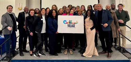 Tourism board representatives and travel advisors posing at Caribbean Village Northeast event