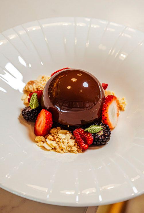 Triple layer chocolate mousse dessert with fresh berries