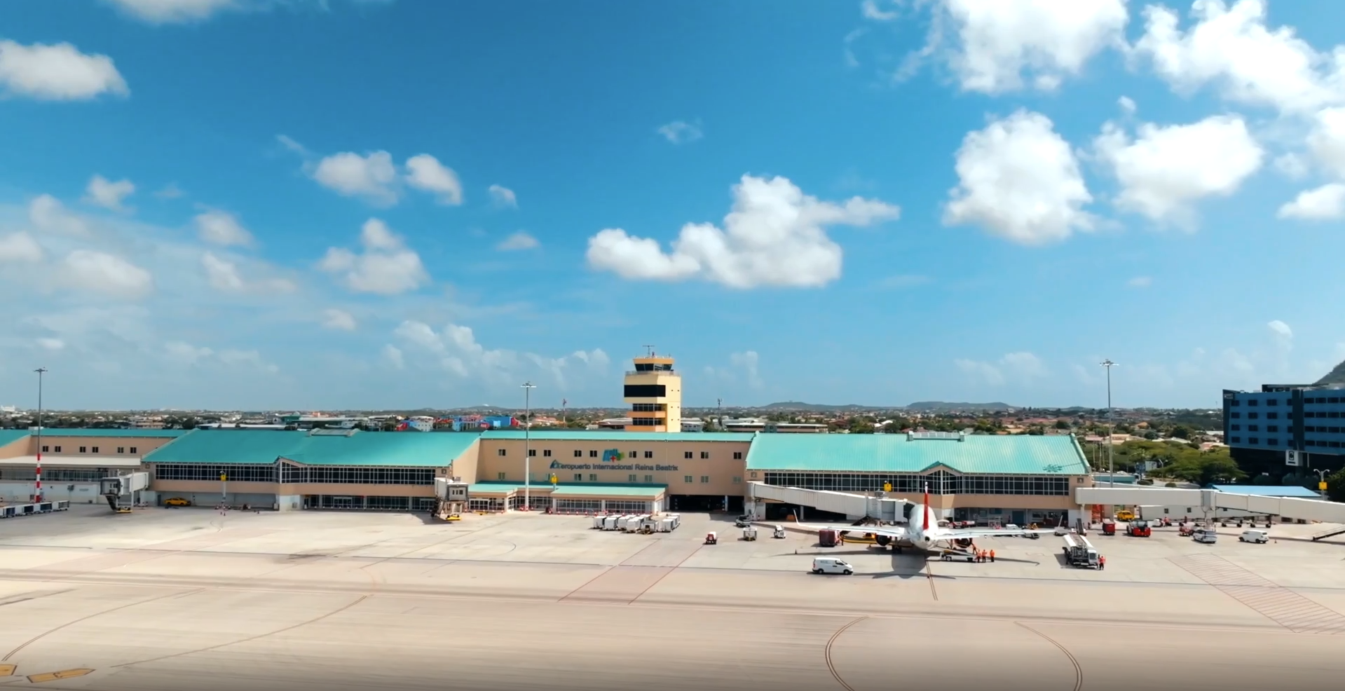 passengers walking through modern Aruba Airport terminal